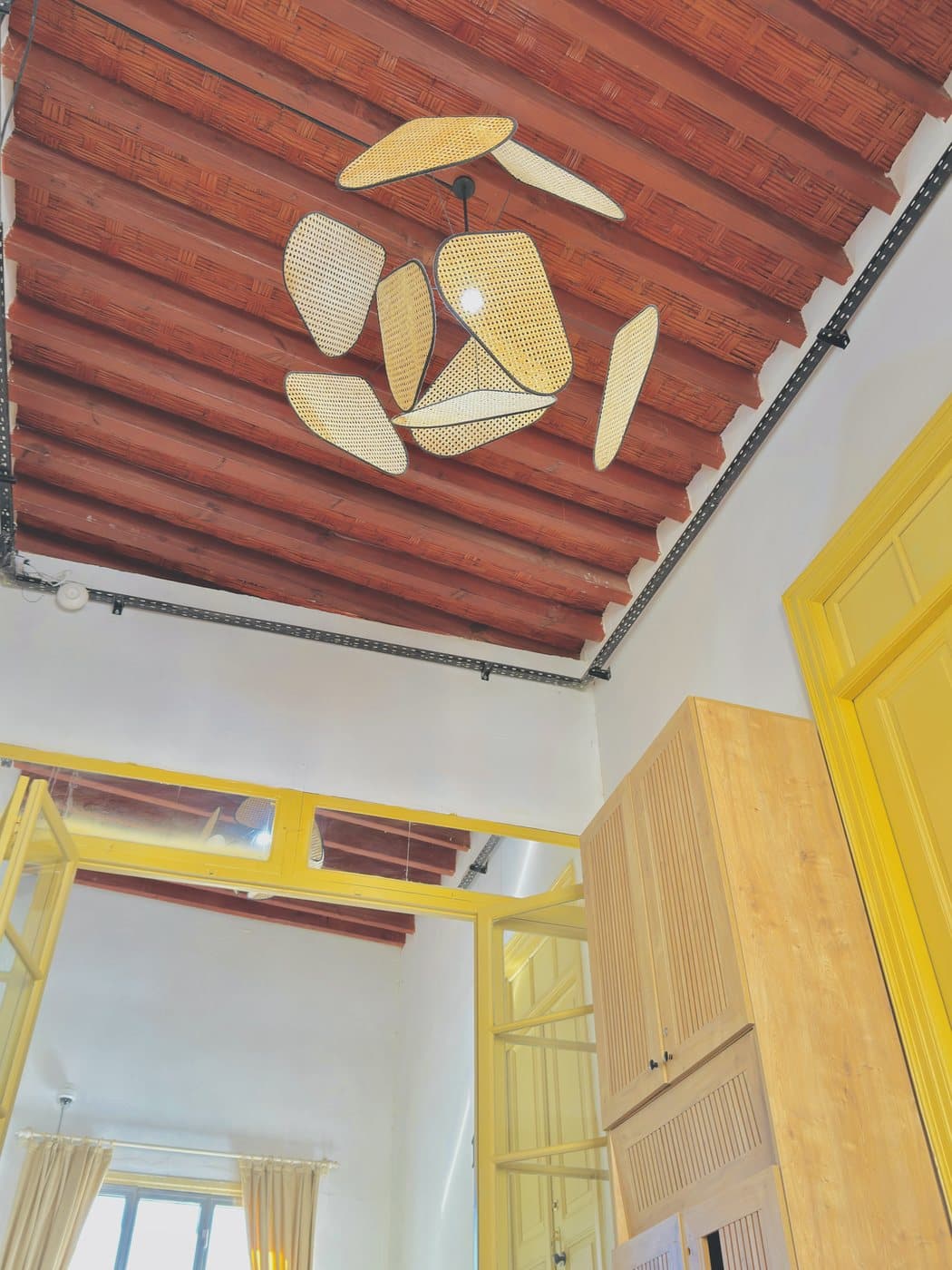 Rattan light and timber ceiling at Avenue Hotel